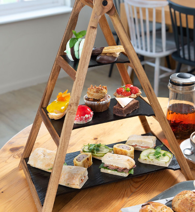 Afternoon tea with sandwiches, cakes and loose-leaf tea