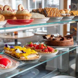 Colourful handmade cakes and tarts in The Wild Strawberry patisserie counter